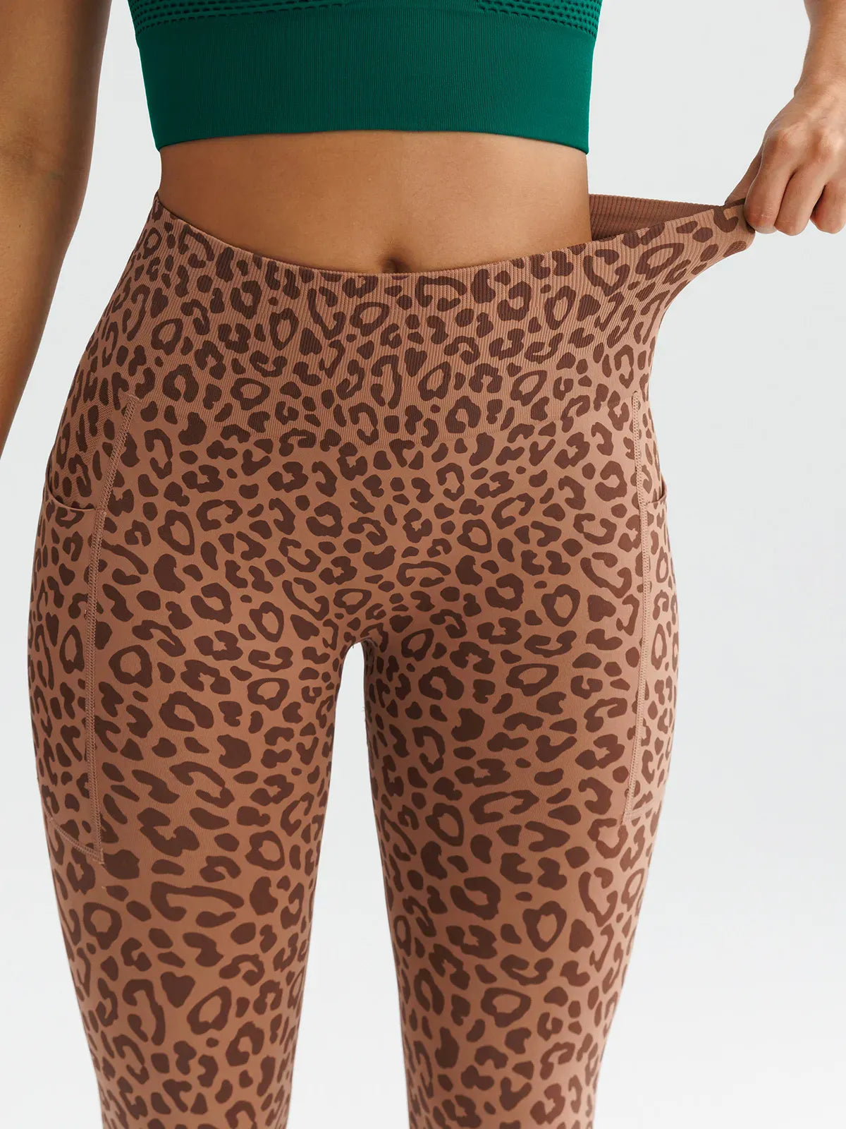A model wearing a BRXL® B R X L™ Seamless High Waisted Butt-Lifting Leggings with Pockets