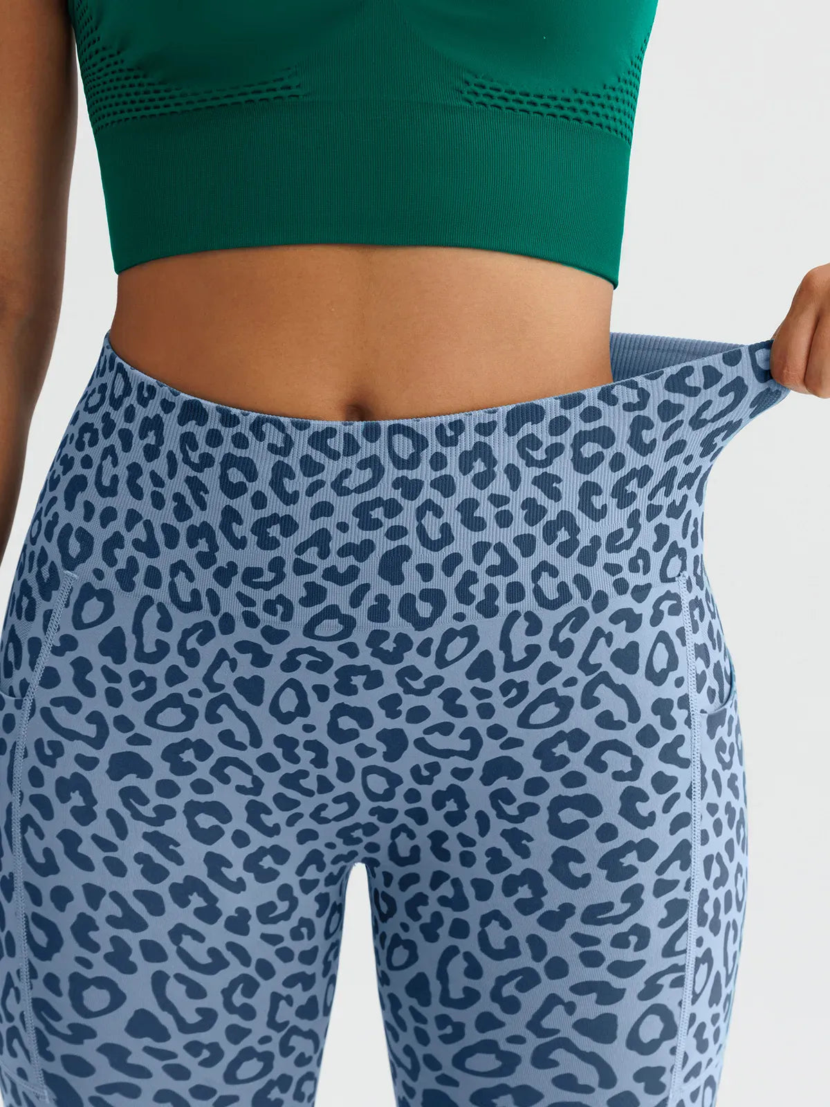A model wearing a BRXL® B R X L™ Seamless High Waisted Butt-Lifting Leggings with Pockets