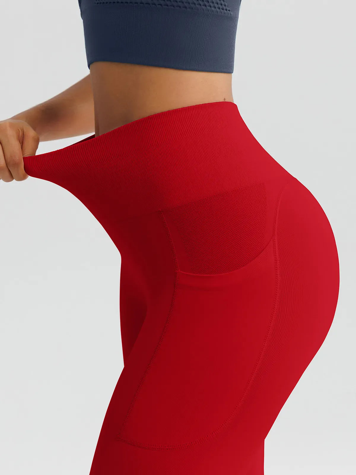 A model wearing a BRXL® B R X L™ Seamless High Waisted Butt-Lifting Leggings with Pockets