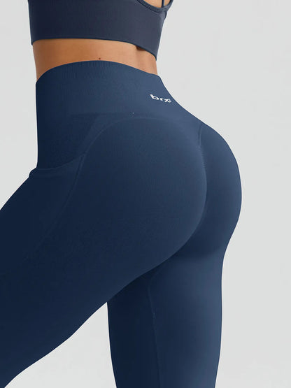A model wearing a BRXL® B R X L™ Seamless High Waisted Butt-Lifting Leggings with Pockets