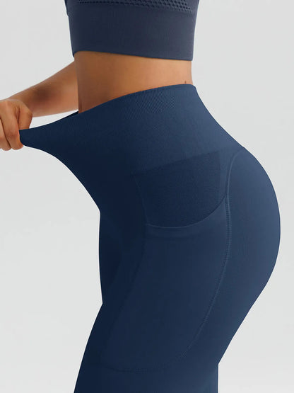 A model wearing a BRXL® B R X L™ Seamless High Waisted Butt-Lifting Leggings with Pockets