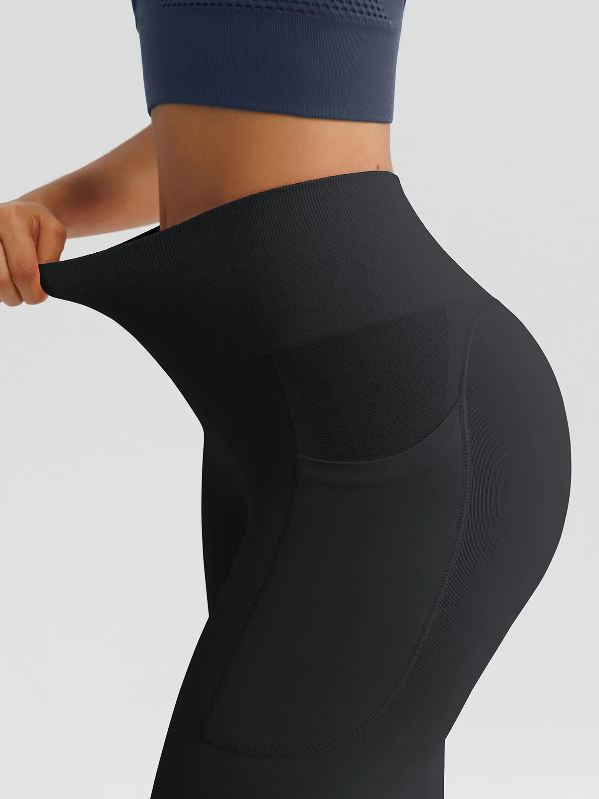 A model wearing a BRXL® B R X L™ Seamless High Waisted Butt-Lifting Leggings with Pockets