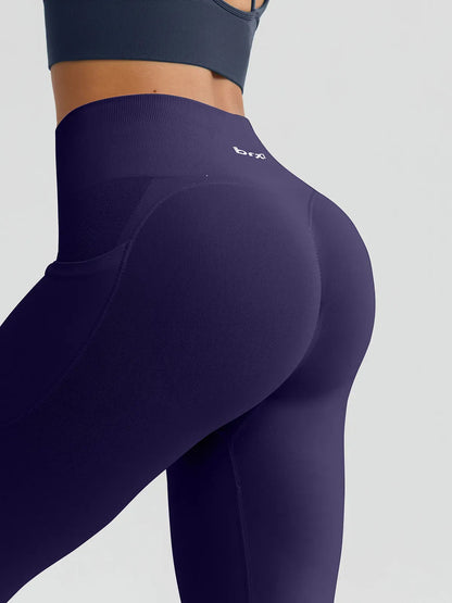 A model wearing a BRXL® B R X L™ Seamless High Waisted Butt-Lifting Leggings with Pockets