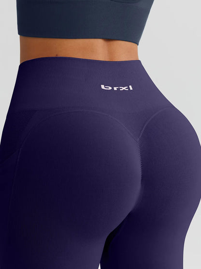 A model wearing a BRXL® B R X L™ Seamless High Waisted Butt-Lifting Leggings with Pockets