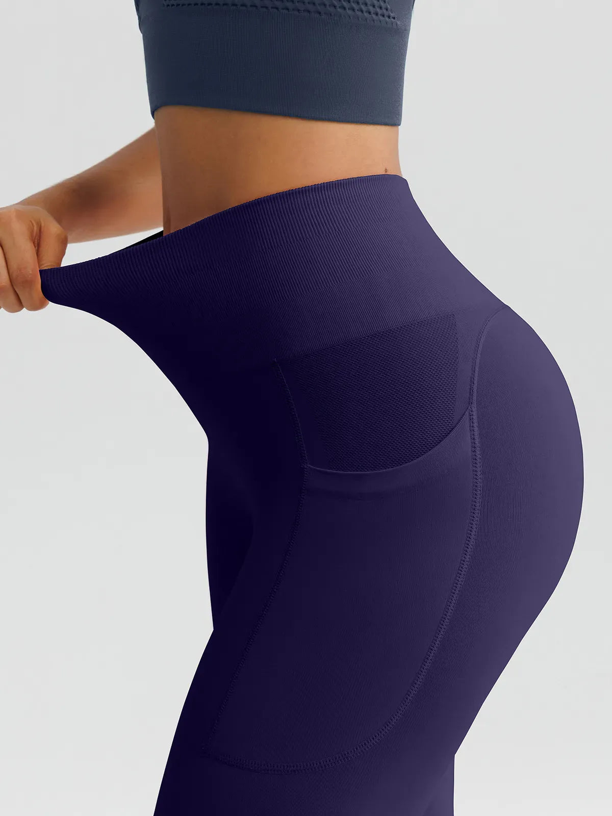 A model wearing a BRXL® B R X L™ Seamless High Waisted Butt-Lifting Leggings with Pockets