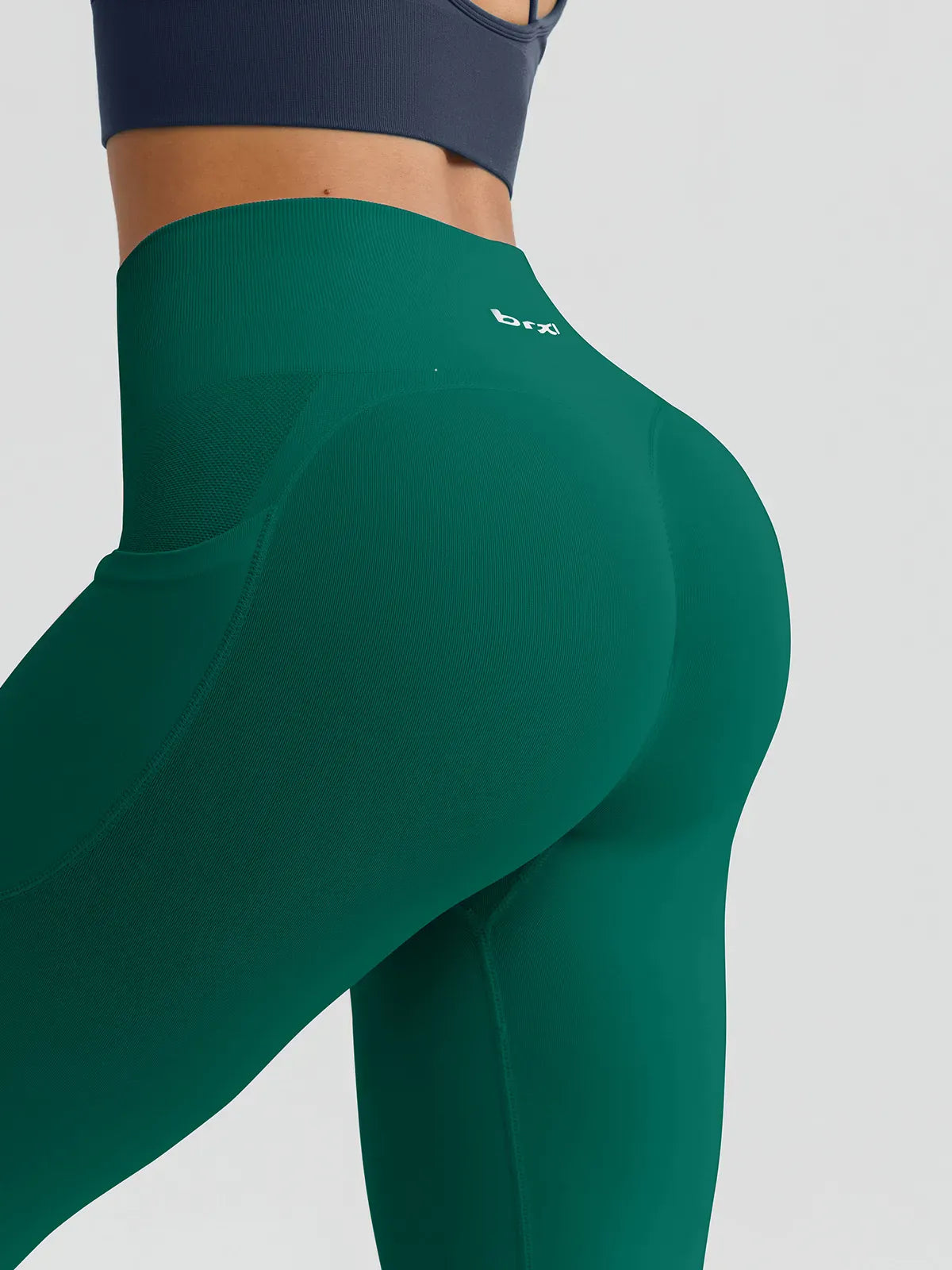 A model wearing a BRXL® B R X L™ Seamless High Waisted Butt-Lifting Leggings with Pockets