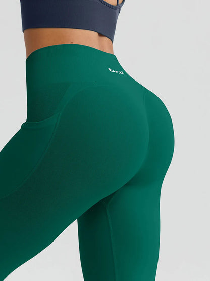 A model wearing a BRXL® B R X L™ Seamless High Waisted Butt-Lifting Leggings with Pockets