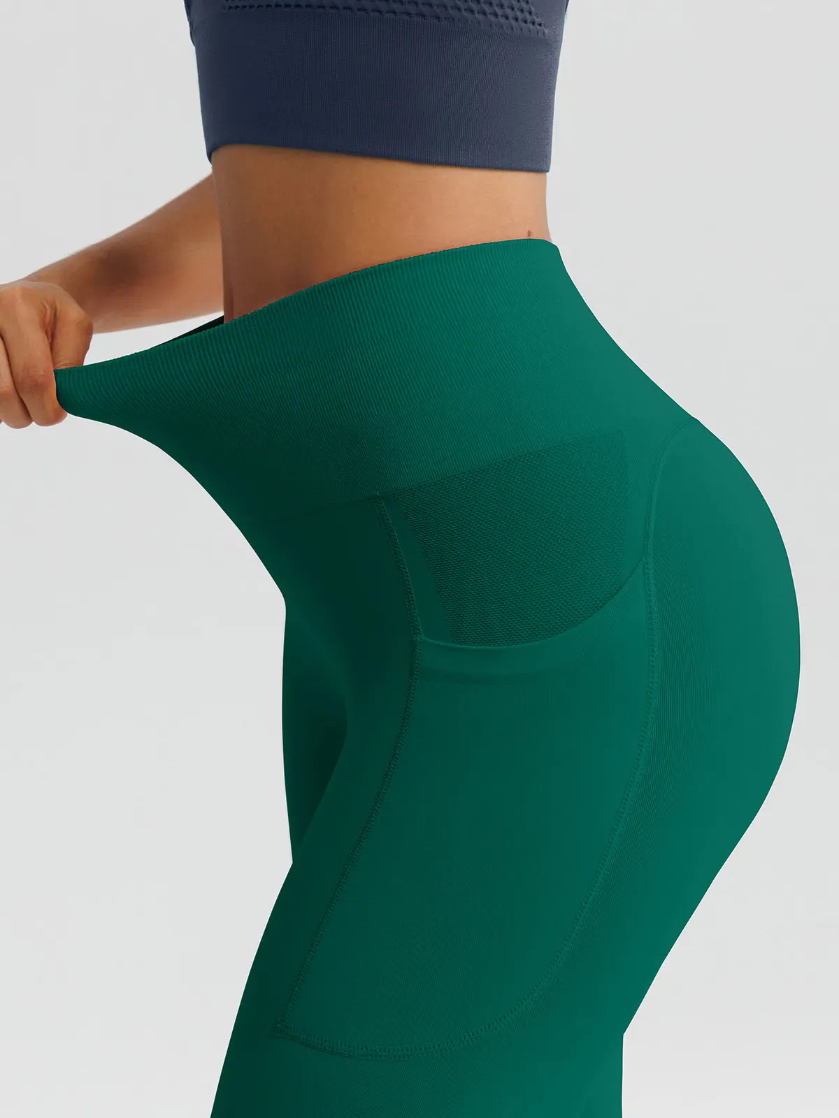 A model wearing a BRXL® B R X L™ Seamless High Waisted Butt-Lifting Leggings with Pockets
