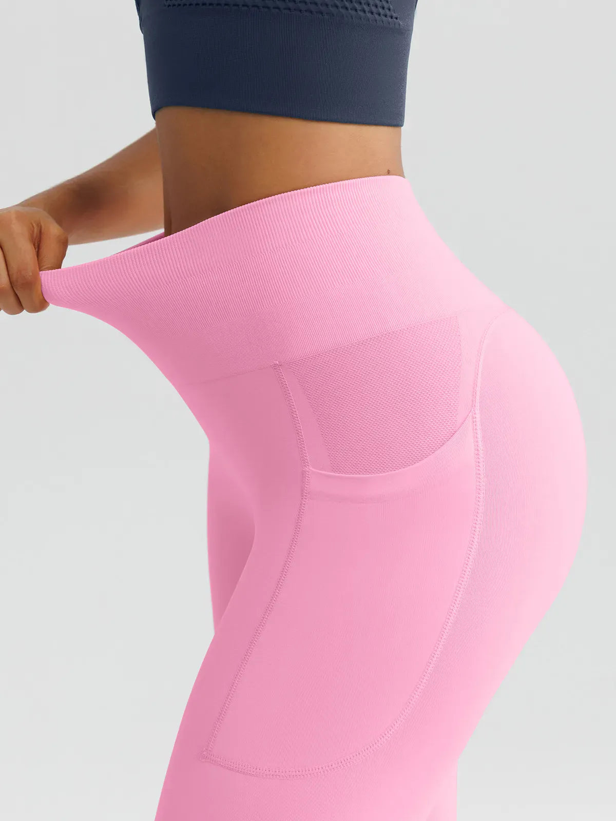 A model wearing a BRXL® B R X L™ Seamless High Waisted Butt-Lifting Leggings with Pockets