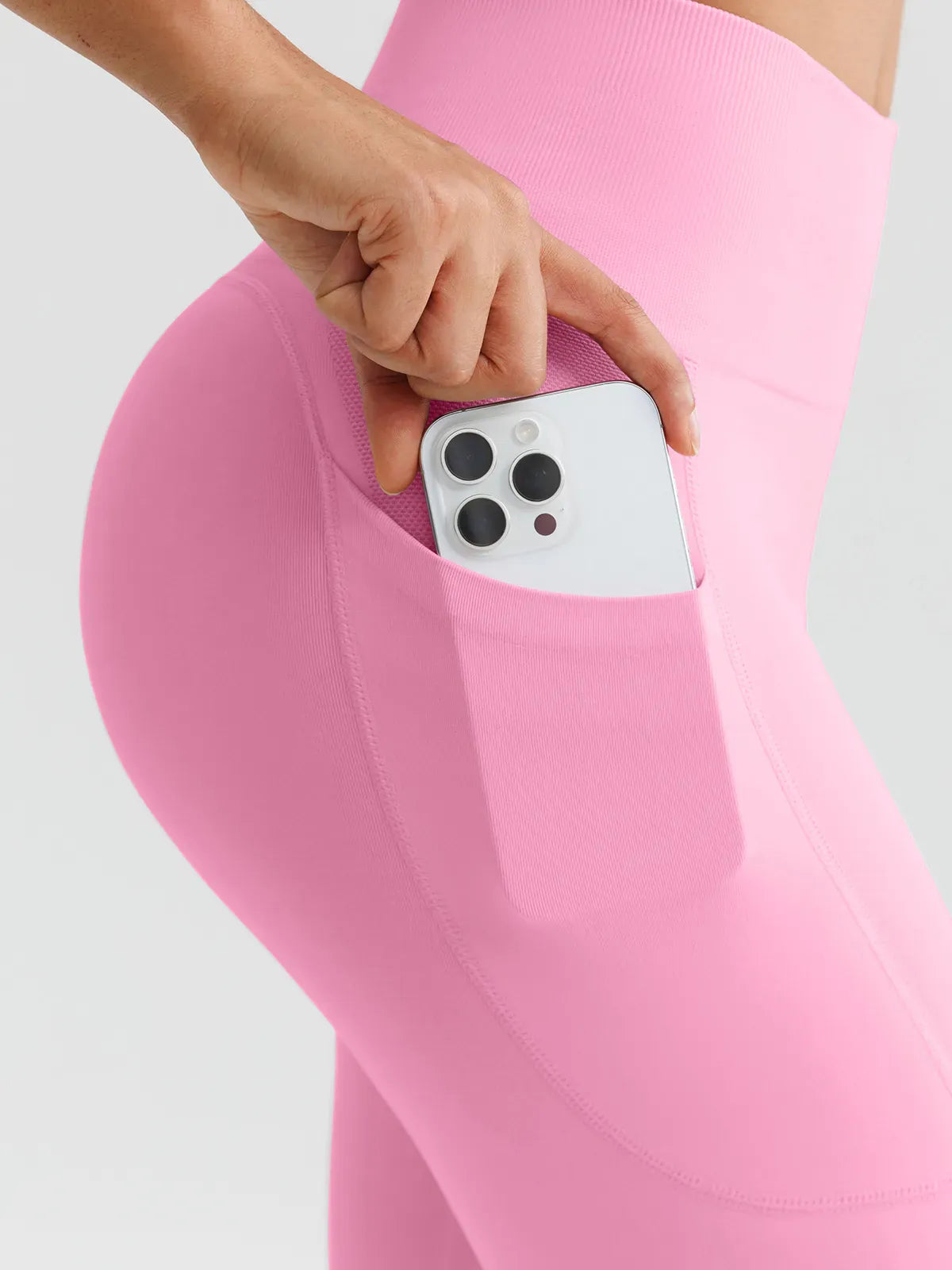 A model wearing a BRXL® B R X L™ Seamless High Waisted Butt-Lifting Leggings with Pockets