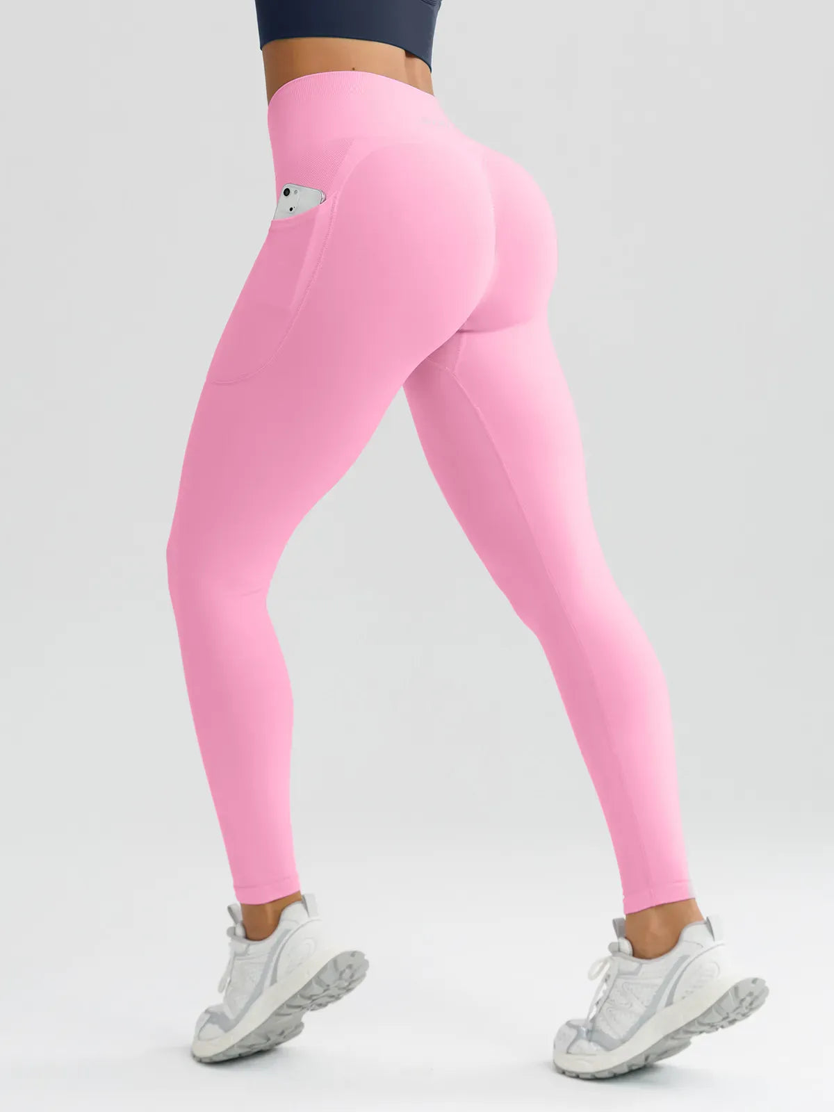A model wearing a BRXL® B R X L™ Seamless High Waisted Butt-Lifting Leggings with Pockets