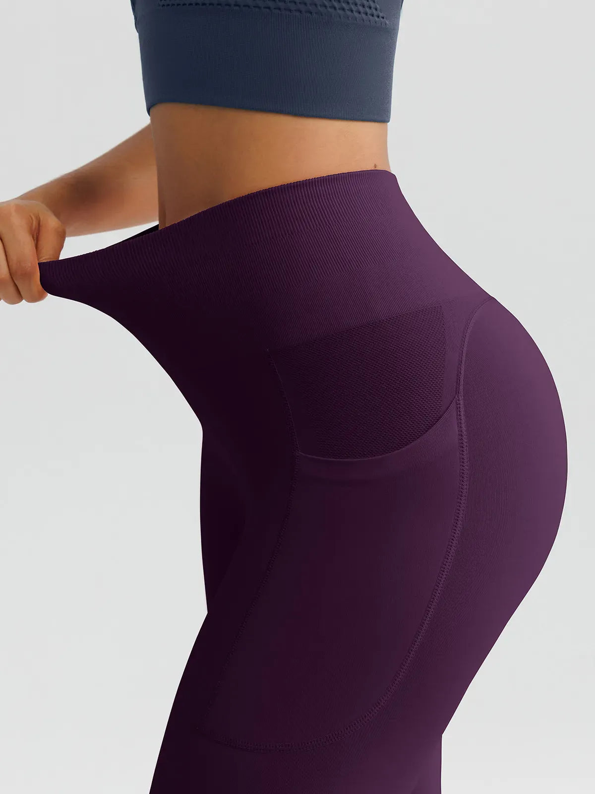 A model wearing a BRXL® B R X L™ Seamless High Waisted Butt-Lifting Leggings with Pockets