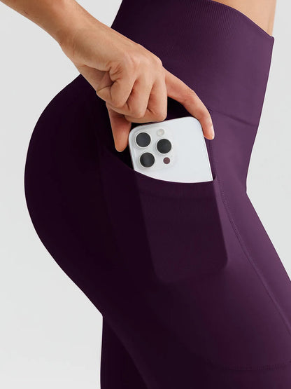 A model wearing a BRXL® B R X L™ Seamless High Waisted Butt-Lifting Leggings with Pockets