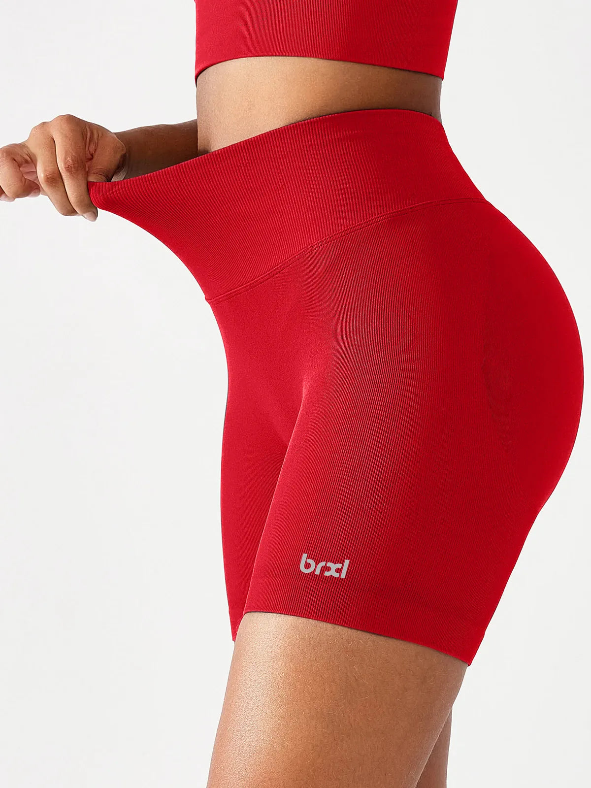 A model wearing a BRXL® B R X L™ Seamless Scrunch Butt Workout Shorts