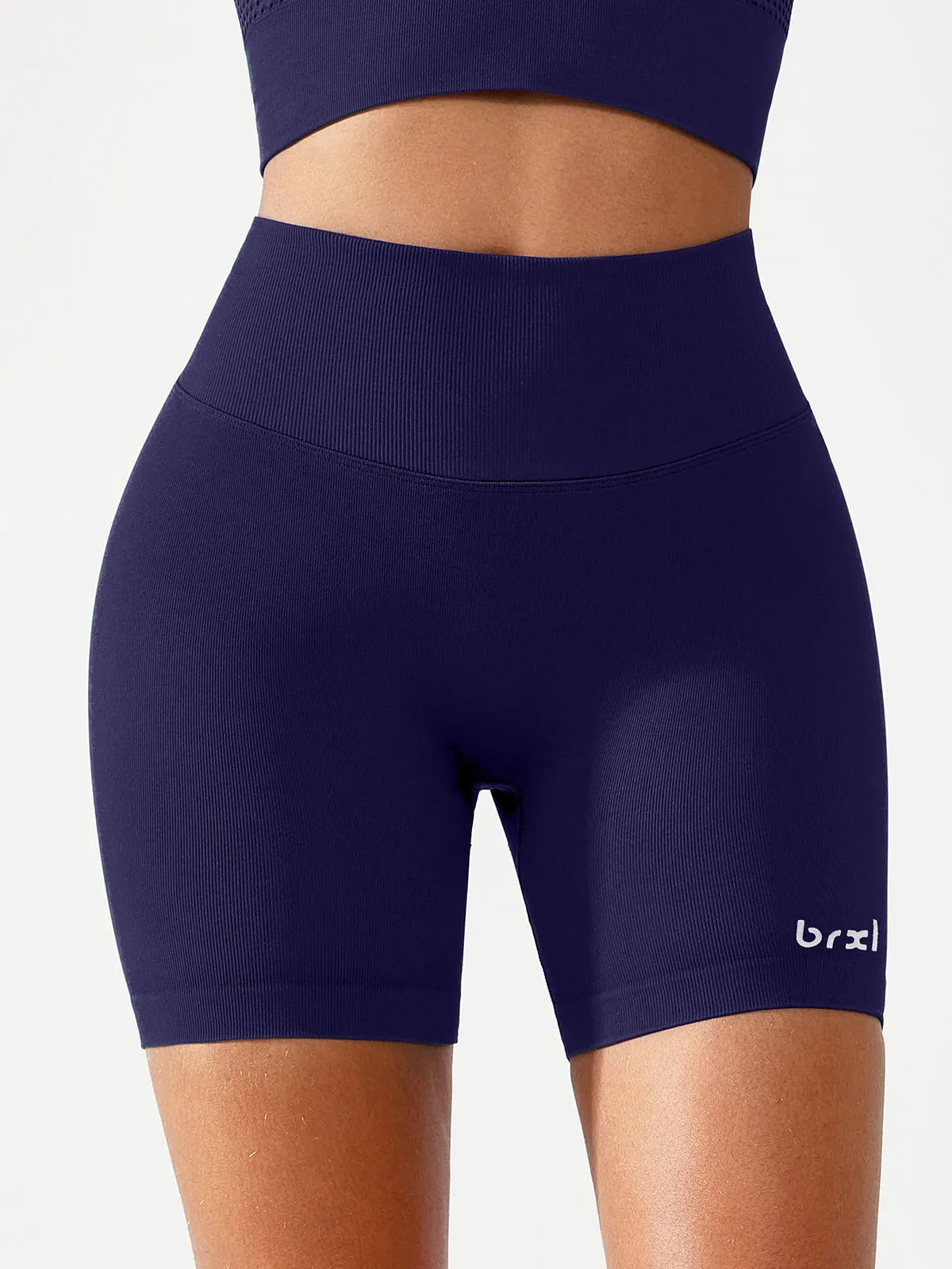 A model wearing a BRXL® B R X L™ Seamless Scrunch Butt Workout Shorts