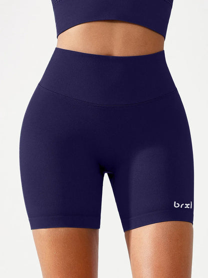 A model wearing a BRXL® B R X L™ Seamless Scrunch Butt Workout Shorts