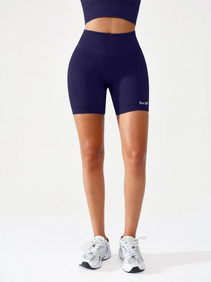A model wearing a BRXL® B R X L™ Seamless Scrunch Butt Workout Shorts