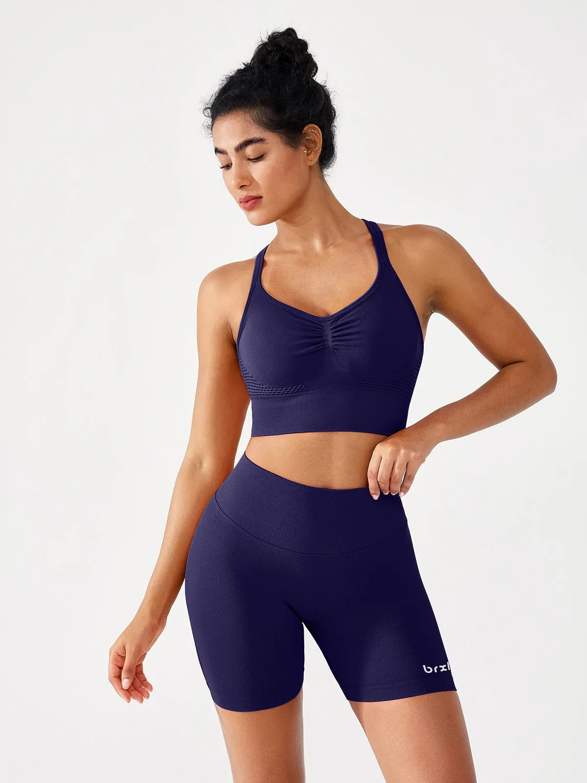 A model wearing a BRXL® B R X L™ Seamless Scrunch Butt Workout Shorts