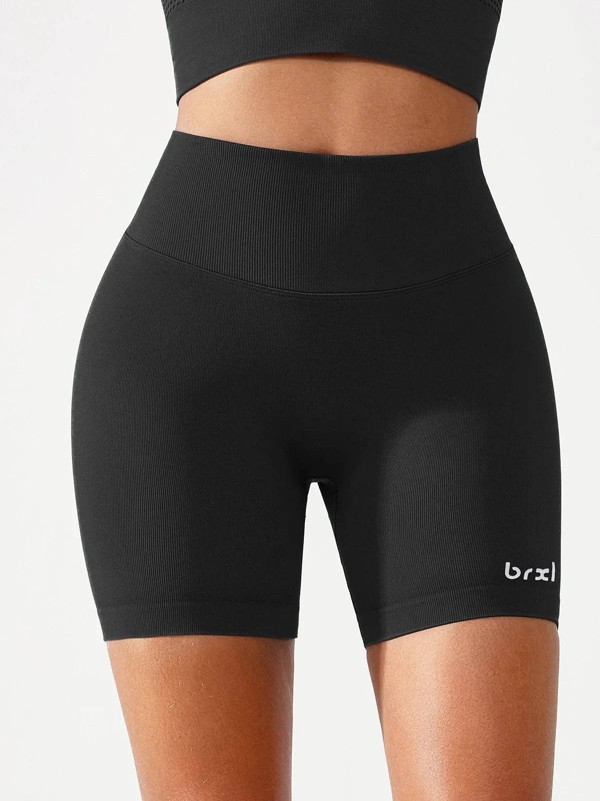 A model wearing a BRXL® B R X L™ Seamless Scrunch Butt Workout Shorts