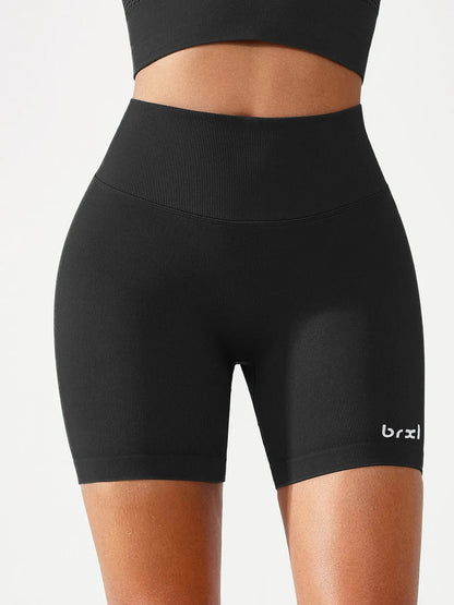 A model wearing a BRXL® B R X L™ Seamless Scrunch Butt Workout Shorts