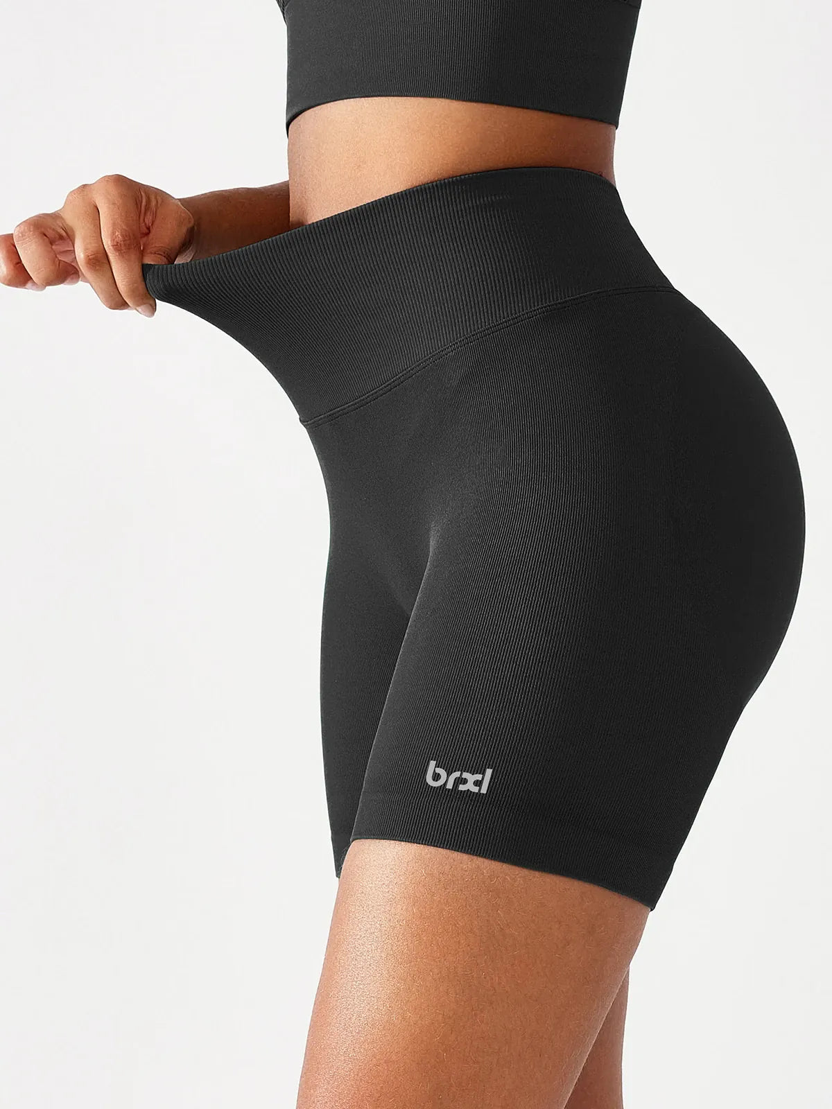 A model wearing a BRXL® B R X L™ Seamless Scrunch Butt Workout Shorts