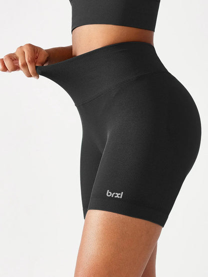 A model wearing a BRXL® B R X L™ Seamless Scrunch Butt Workout Shorts