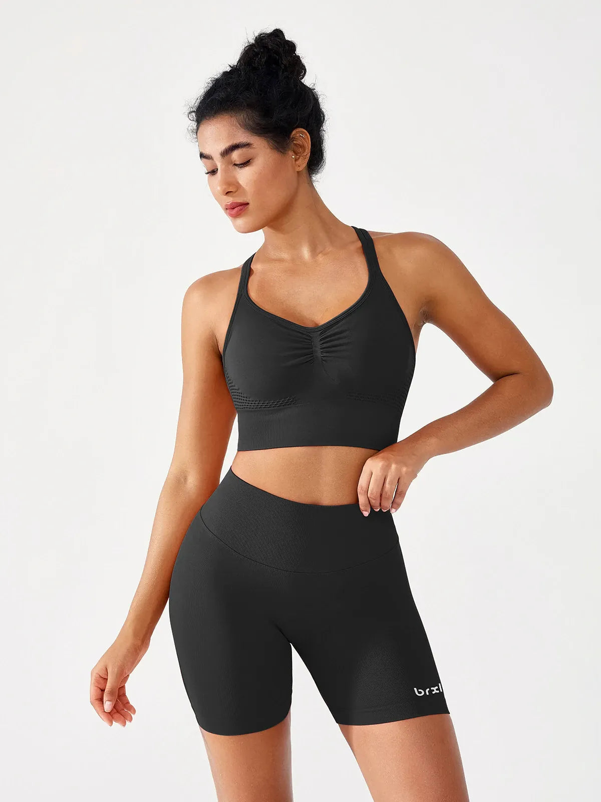 A model wearing a BRXL® B R X L™ Seamless Scrunch Butt Workout Shorts