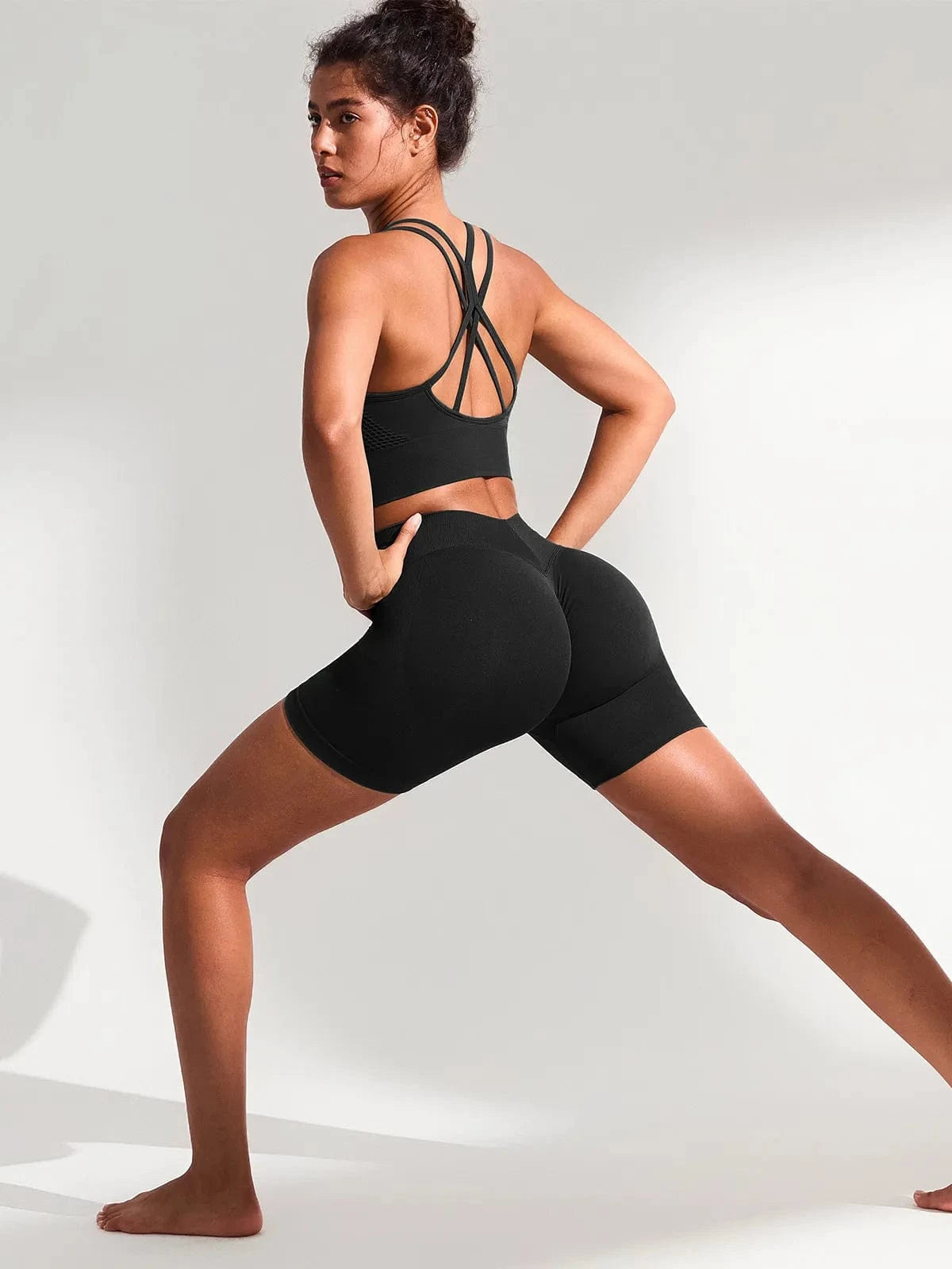 A model wearing a BRXL® BrxlGrit™ Seamless Scrunch Butt Workout Shorts in