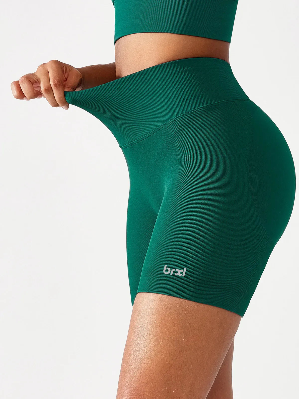 A model wearing a BRXL® B R X L™ Seamless Scrunch Butt Workout Shorts