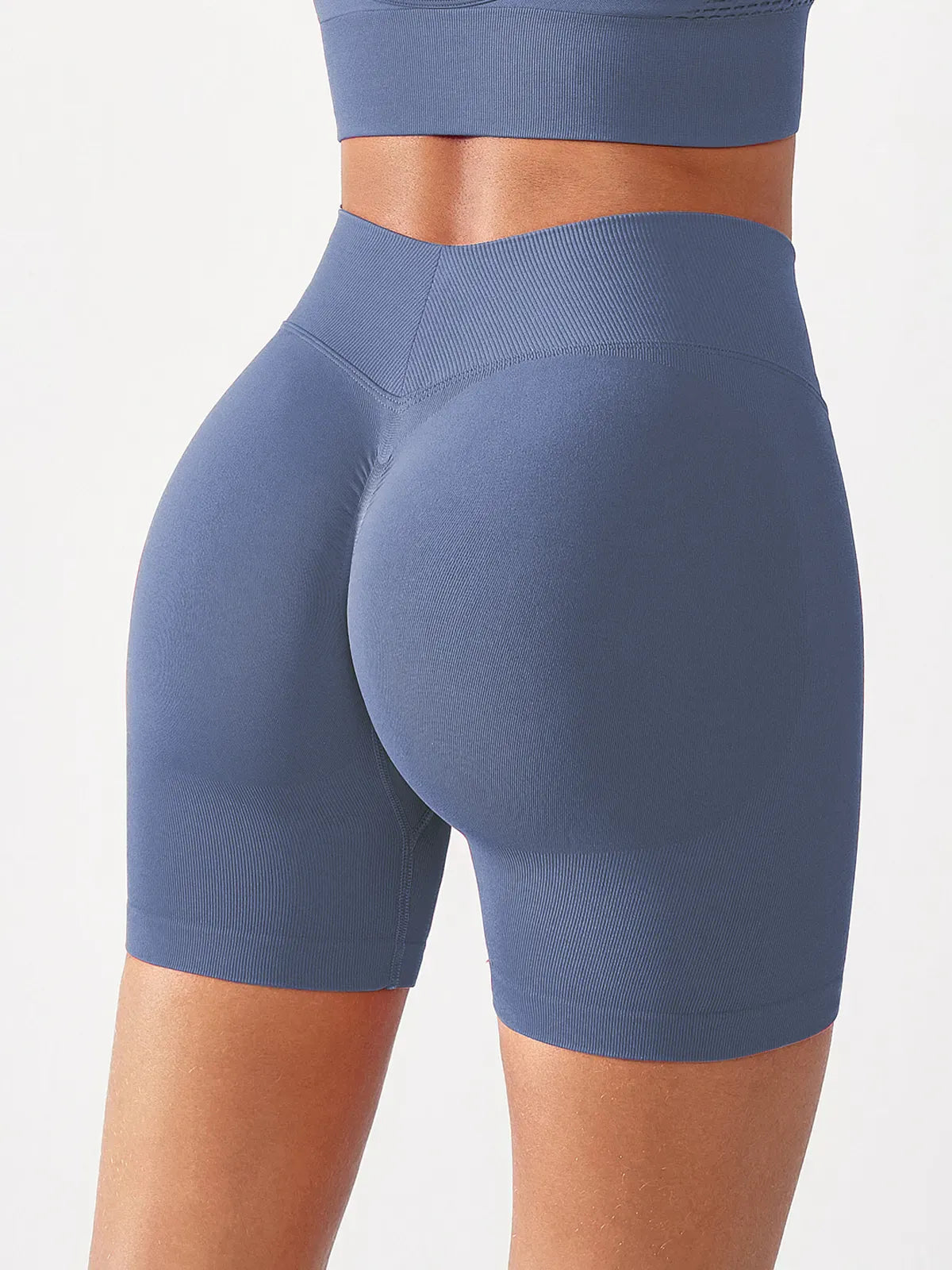 A model wearing a BRXL® B R X L™ Seamless Scrunch Butt Workout Shorts