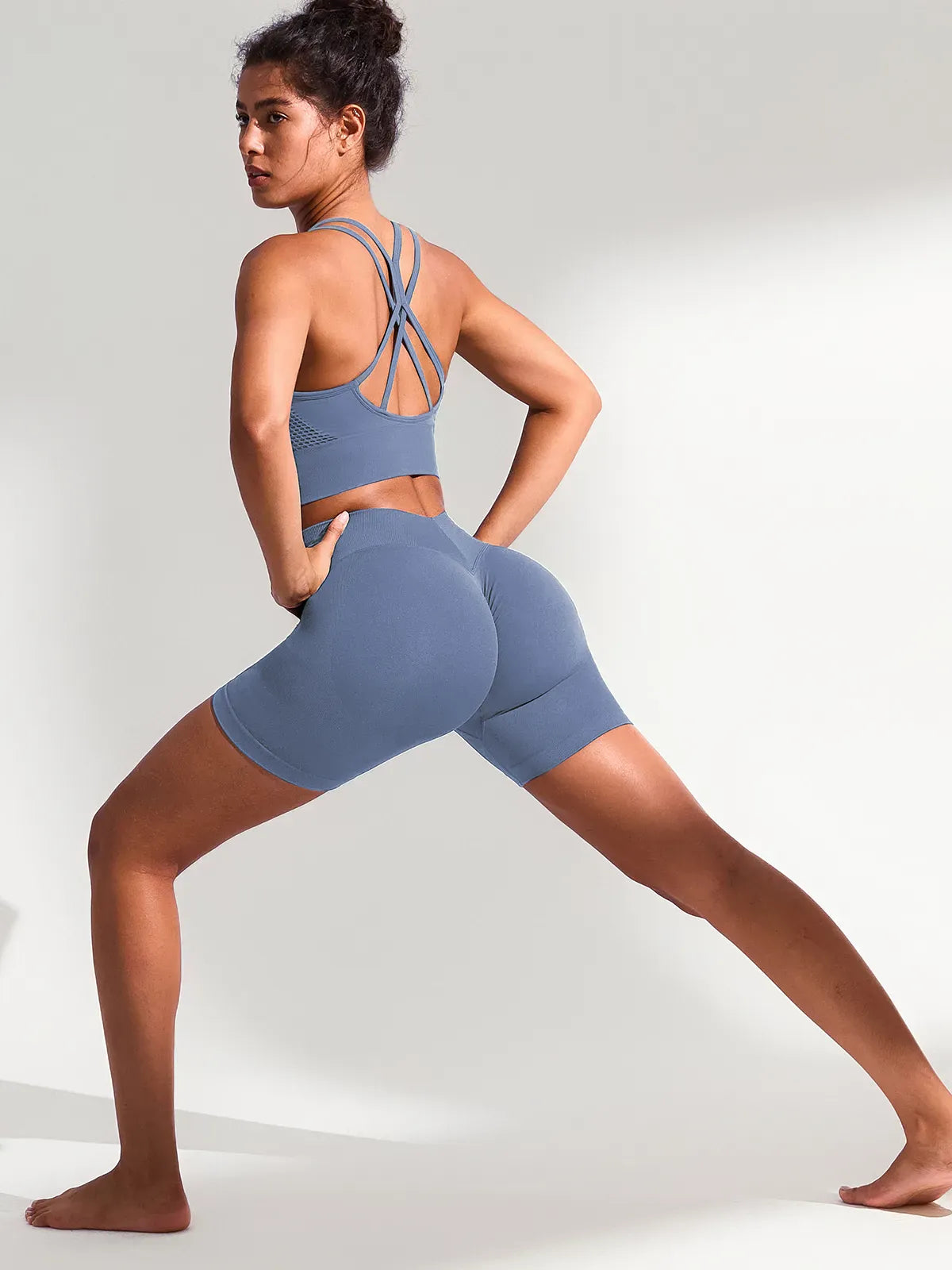 A model wearing a BRXL® B R X L™ Seamless Scrunch Butt Workout Shorts