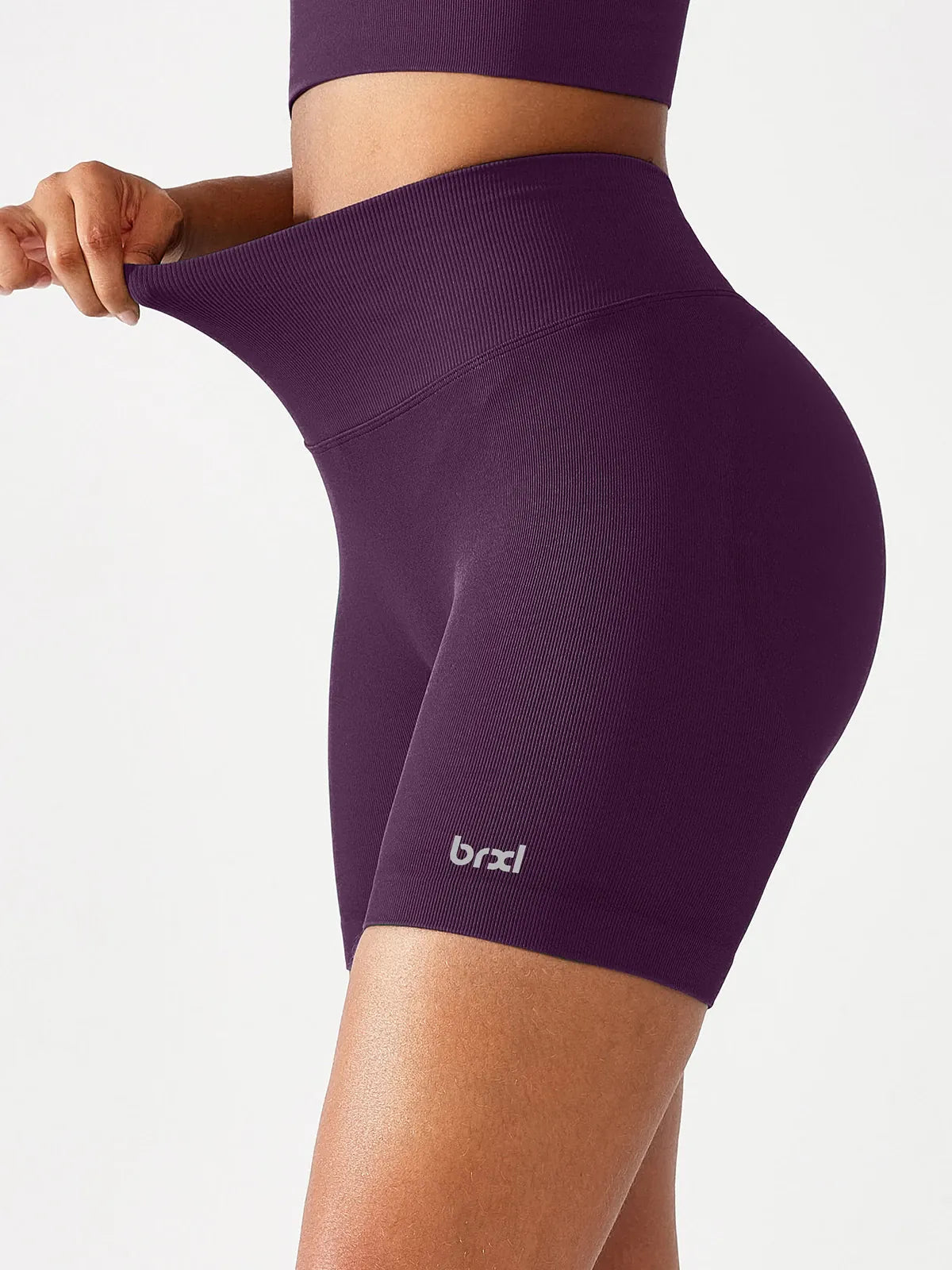 A model wearing a BRXL® B R X L™ Seamless Scrunch Butt Workout Shorts