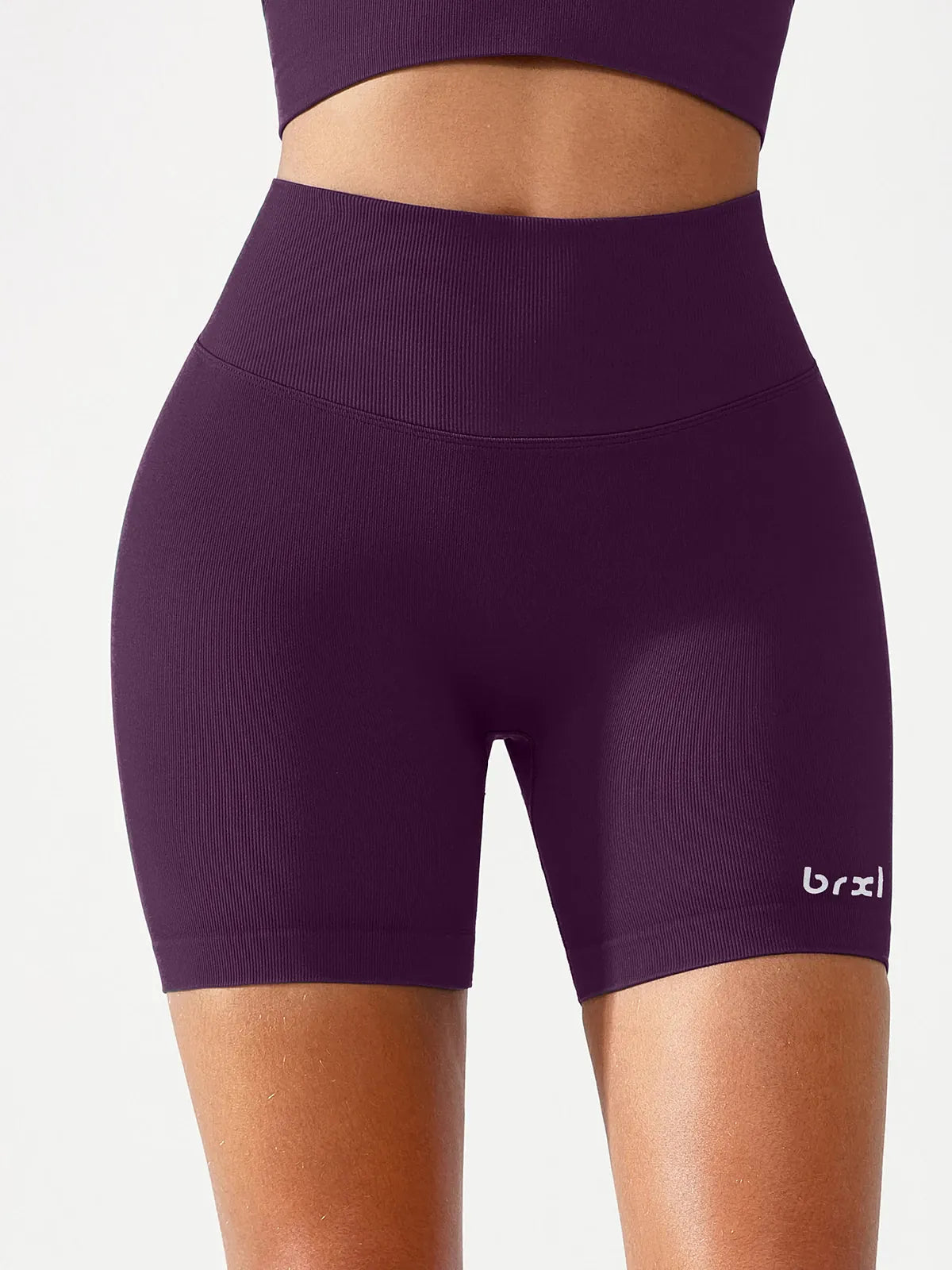 A model wearing a BRXL® B R X L™ Seamless Scrunch Butt Workout Shorts