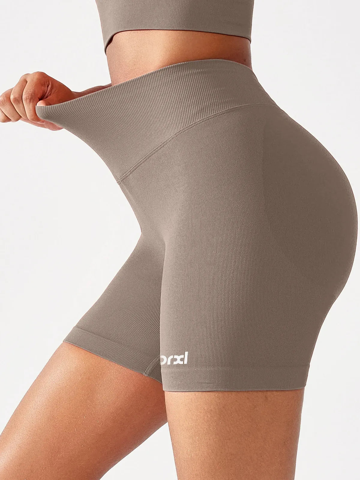 A model wearing a BRXL® B R X L™ Seamless Scrunch Butt Workout Shorts
