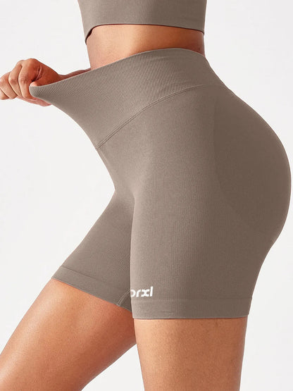 A model wearing a BRXL® B R X L™ Seamless Scrunch Butt Workout Shorts