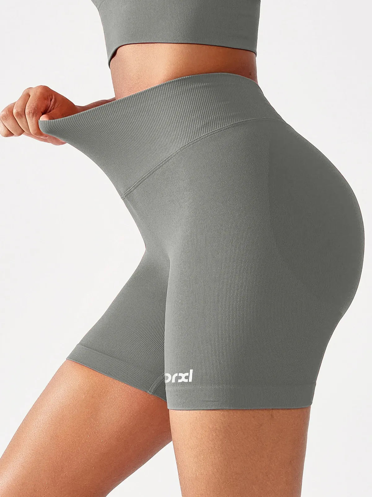 A model wearing a BRXL® B R X L™ Seamless Scrunch Butt Workout Shorts