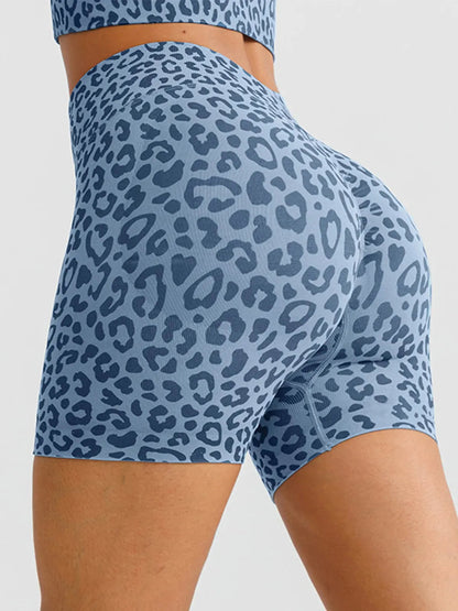 A model wearing a BRXL® B R X L™ Seamless Scrunch Butt Workout Shorts Blue Leopard / XS