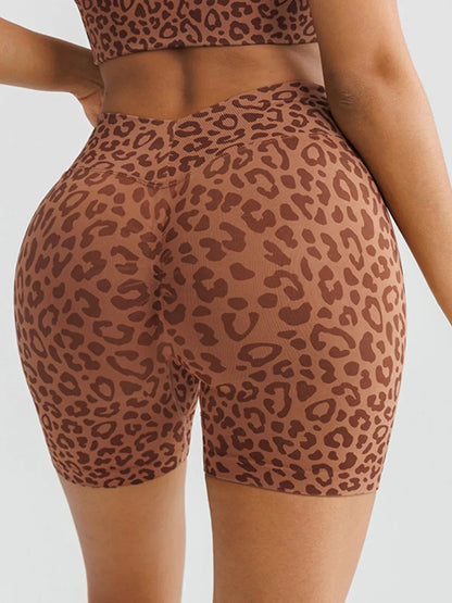 A model wearing a BRXL® B R X L™ Seamless Scrunch Butt Workout Shorts Leopard / XS