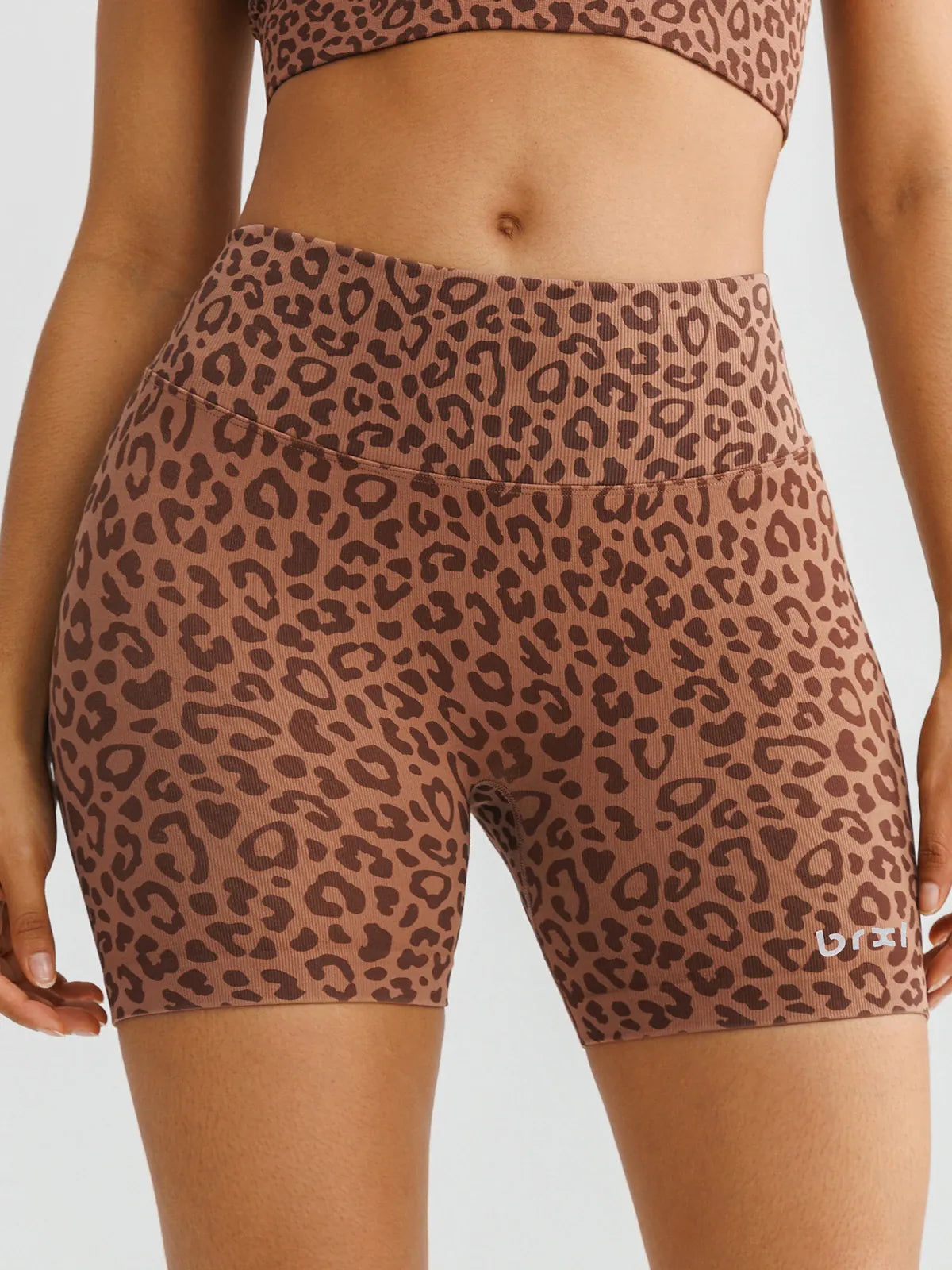 A model wearing a BRXL® B R X L™ Seamless Scrunch Butt Workout Shorts