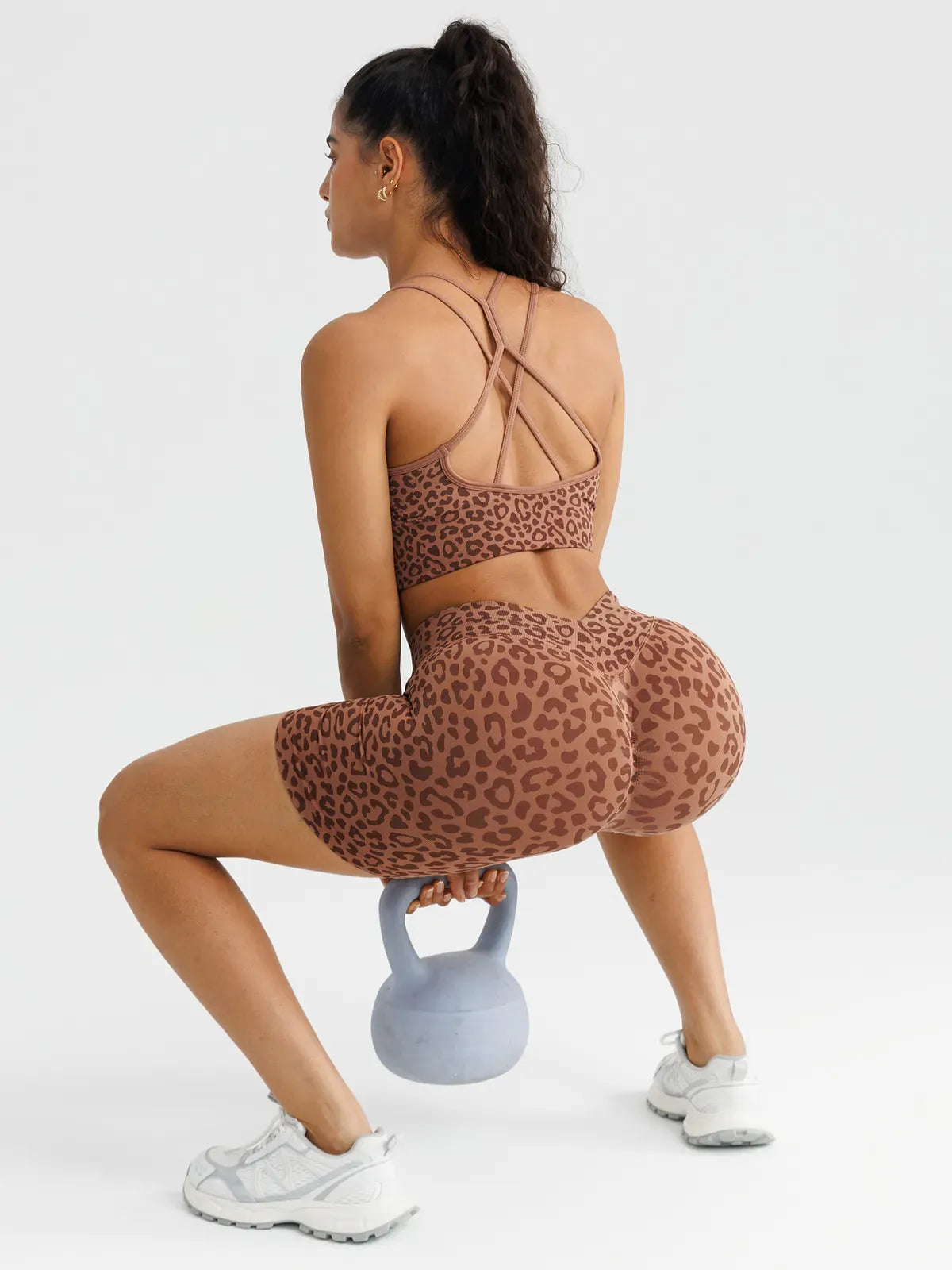 A model wearing a BRXL® B R X L™ Seamless Scrunch Butt Workout Shorts