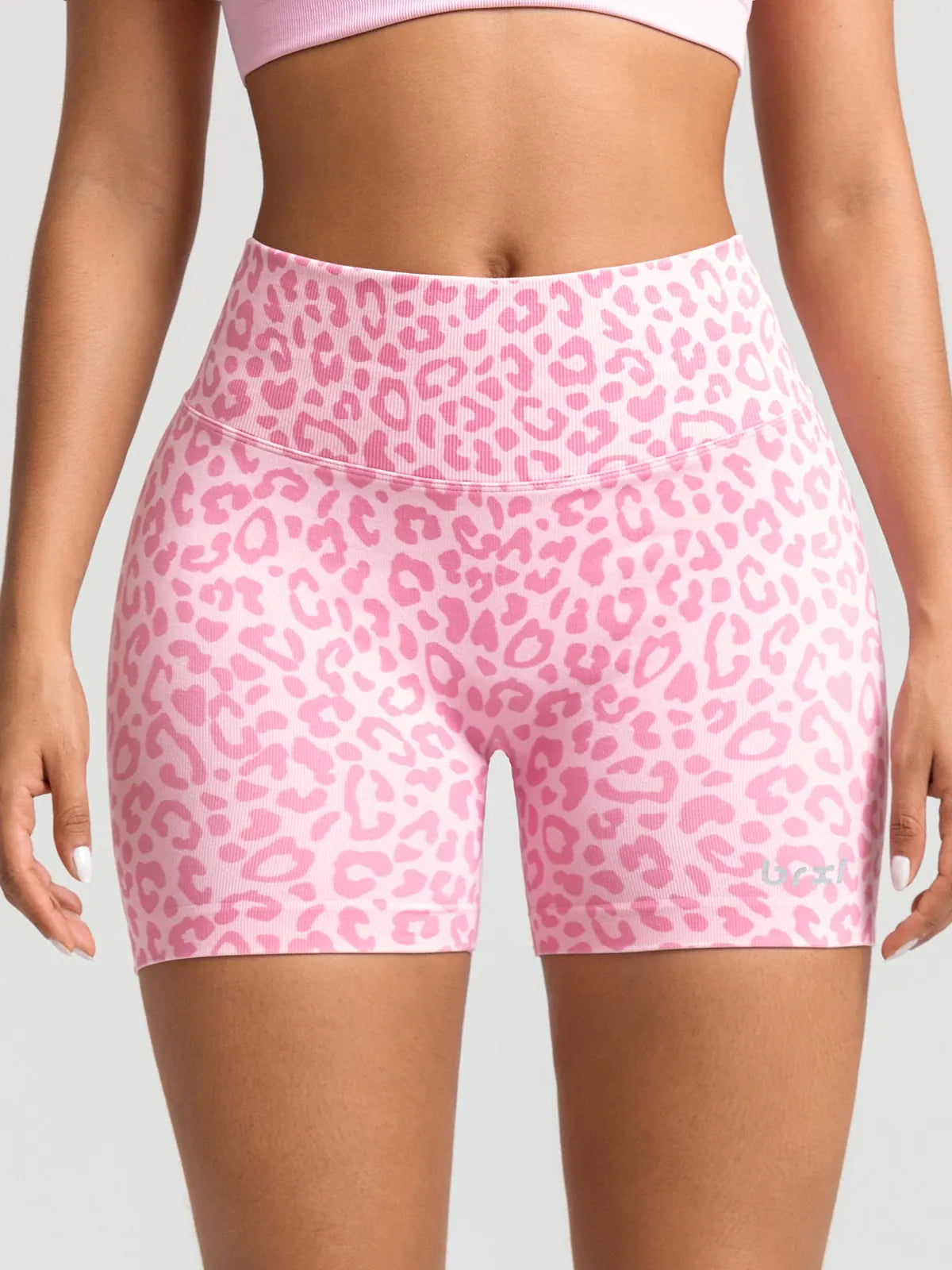 A model wearing a BRXL® B R X L™ Seamless Scrunch Butt Workout Shorts