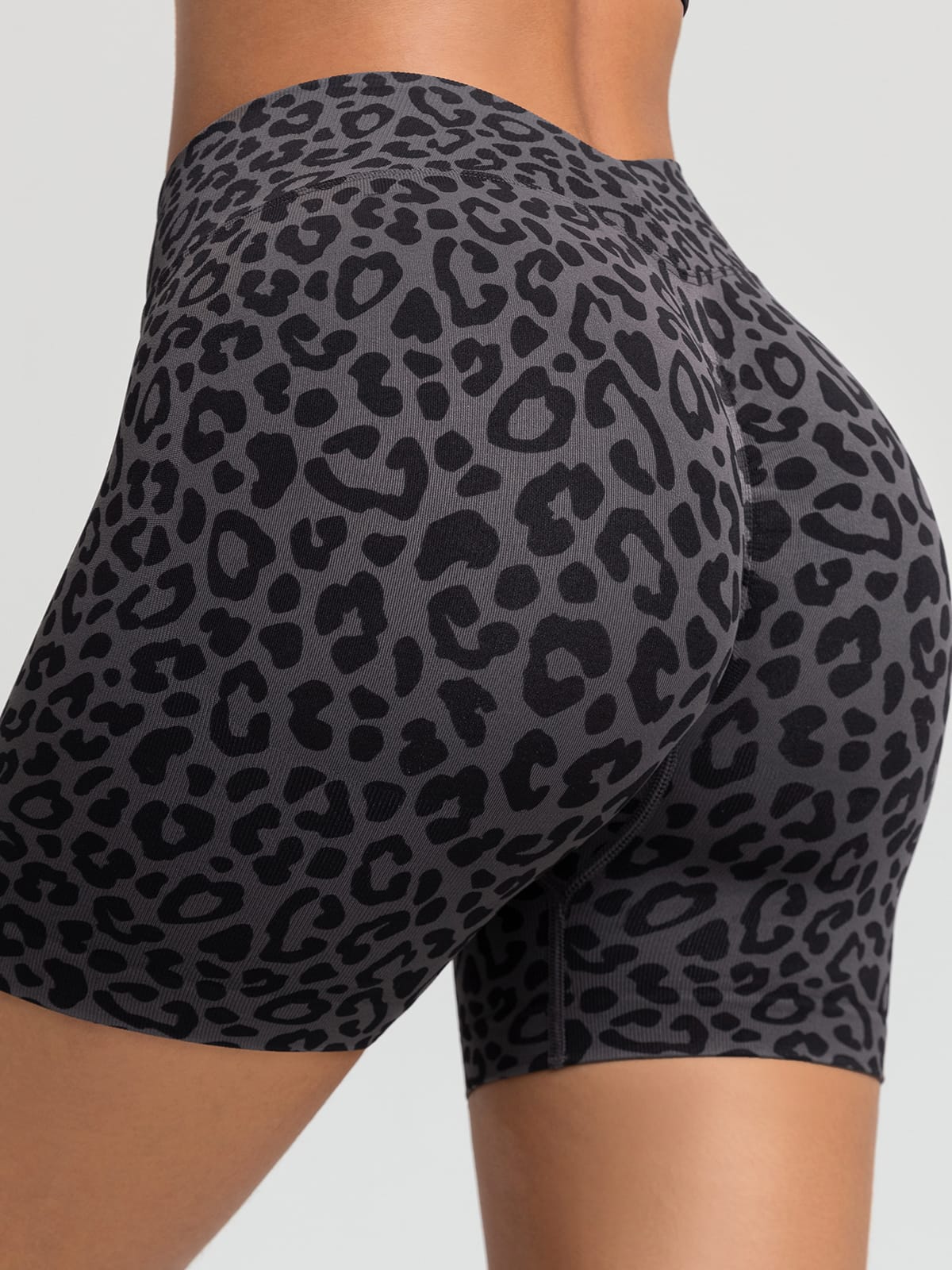 A model wearing a BRXL® B R X L™ Seamless Scrunch Butt Workout Shorts Grey Leopard / XS