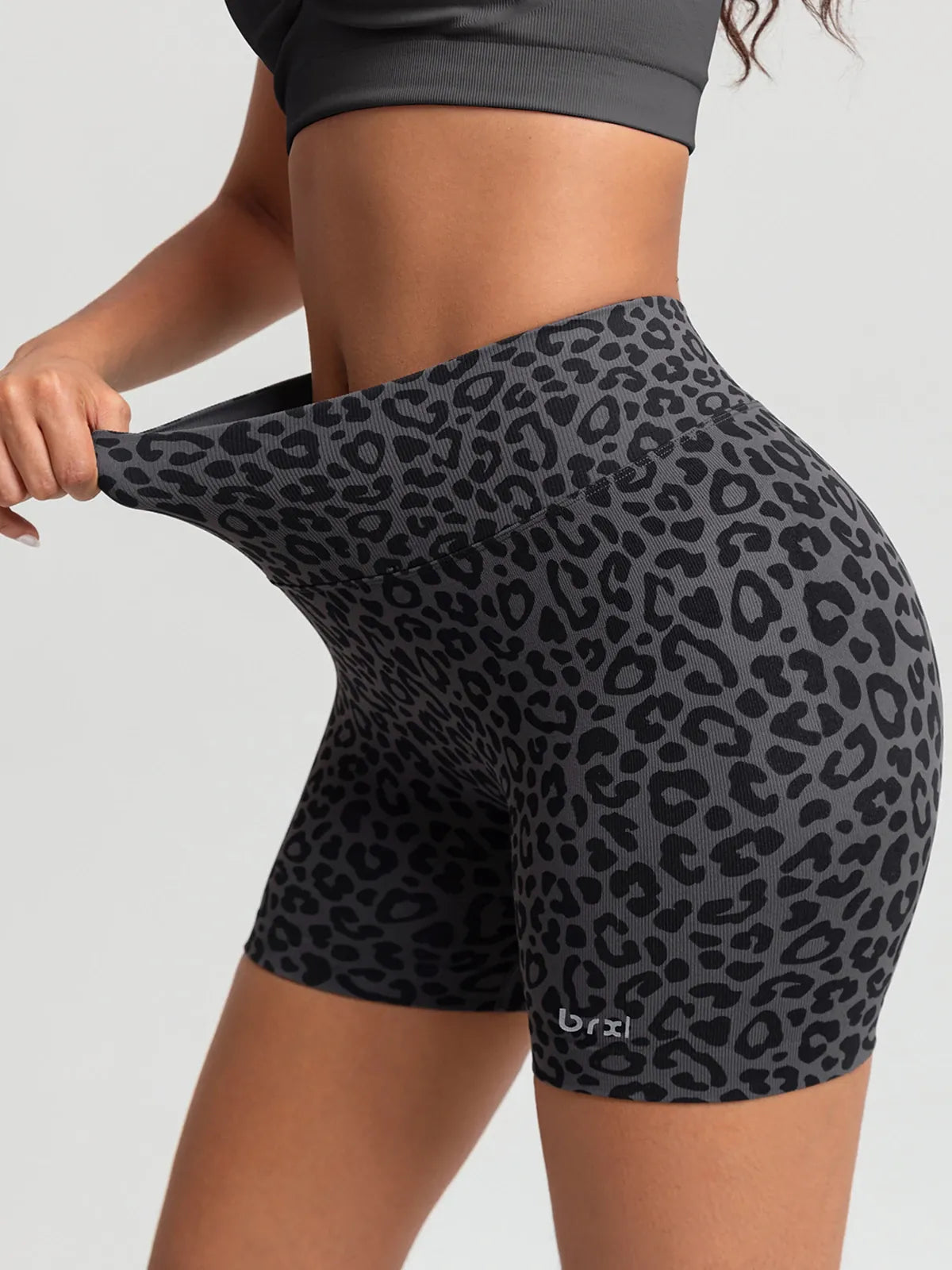 A model wearing a BRXL® B R X L™ Seamless Scrunch Butt Workout Shorts