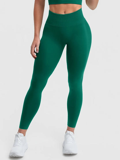A model wearing a BRXL® STAYLAT™ Seamless High-Rise Sculpt Anti-Roll Leggings 3.0 Dark Green / XS