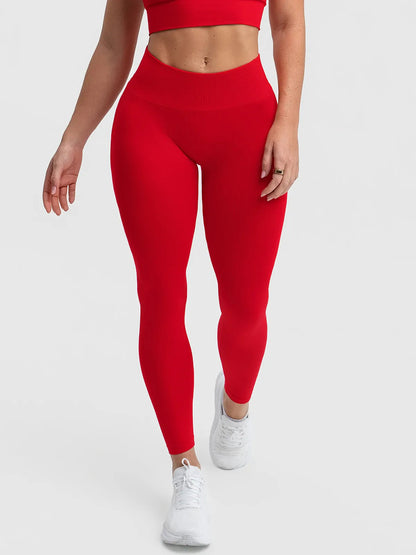 A model wearing a BRXL® STAYLAT™ Seamless High-Rise Sculpt Anti-Roll Leggings 3.0 Ruby Red / XS