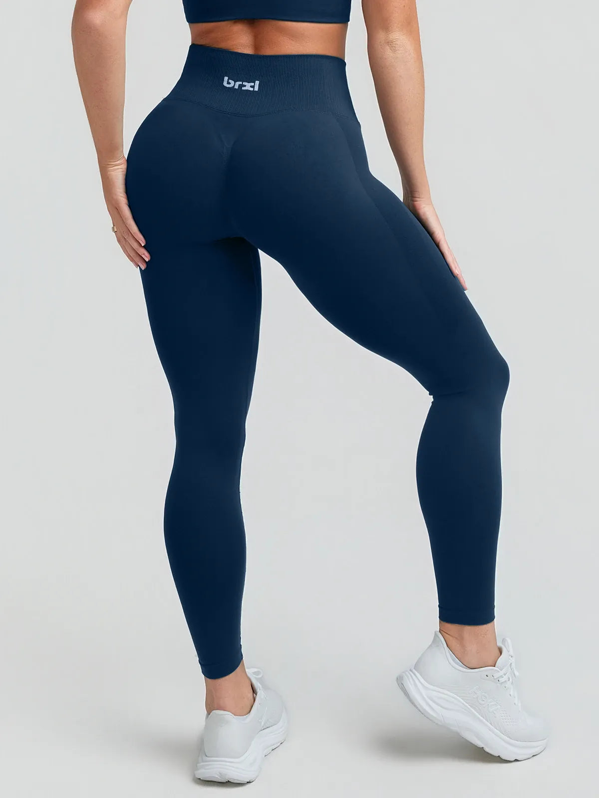 A model wearing a BRXL® STAYLAT™ Seamless High-Rise Sculpt Anti-Roll Leggings 3.0