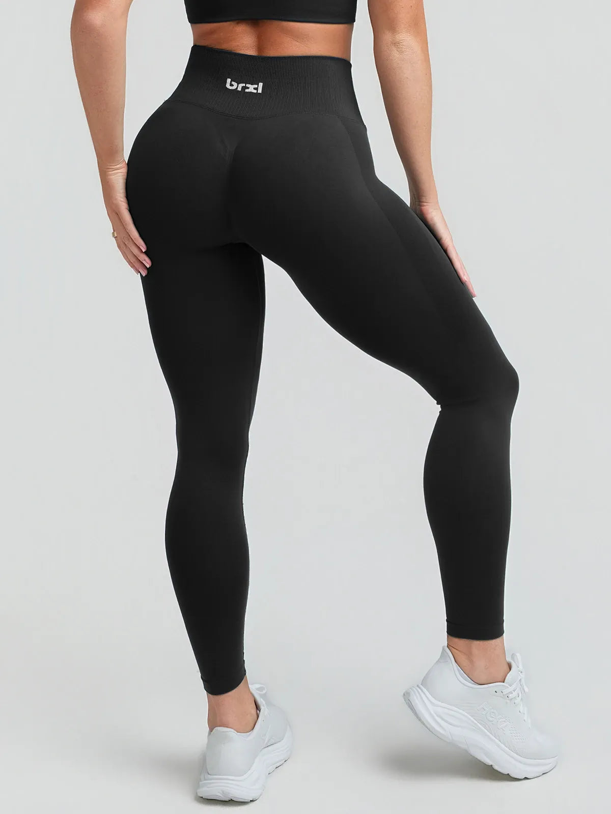A model wearing a BRXL® STAYLAT™ Seamless High-Rise Sculpt Anti-Roll Leggings 3.0