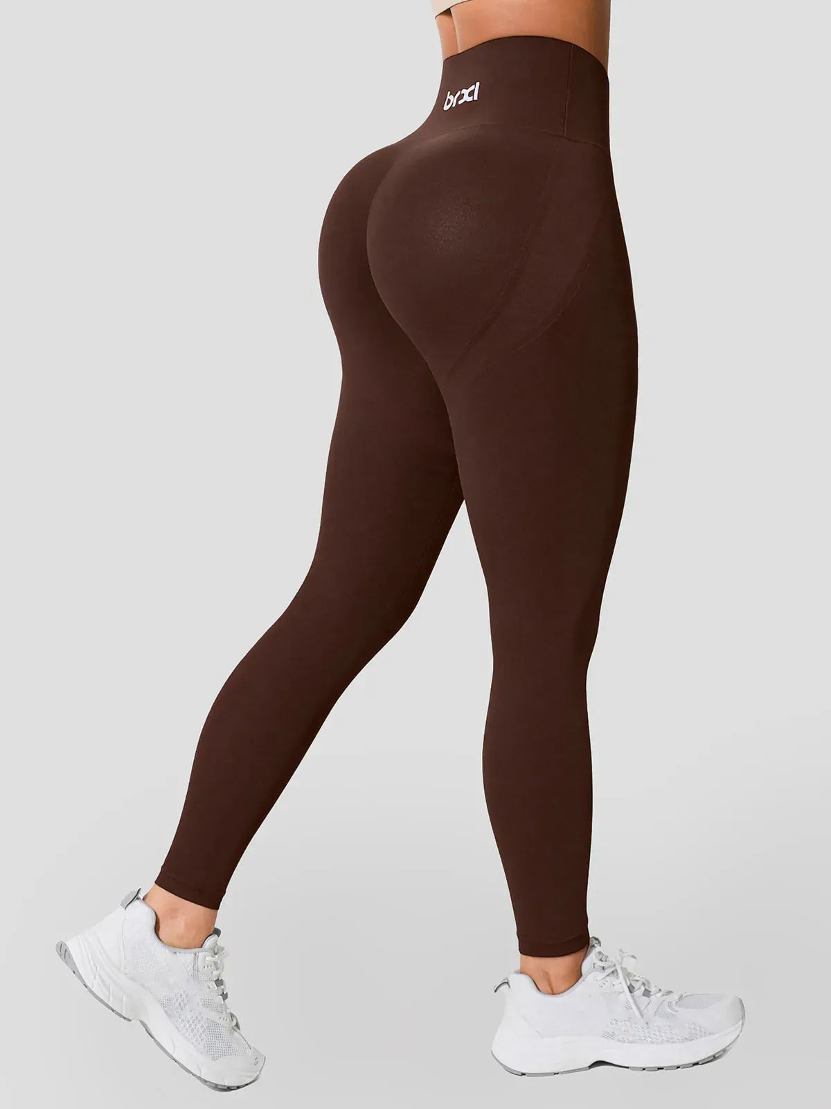 A model wearing a BRXL® High Waisted Seamless Butt-Lifting Leggings With Tummy Control in Brown / XS