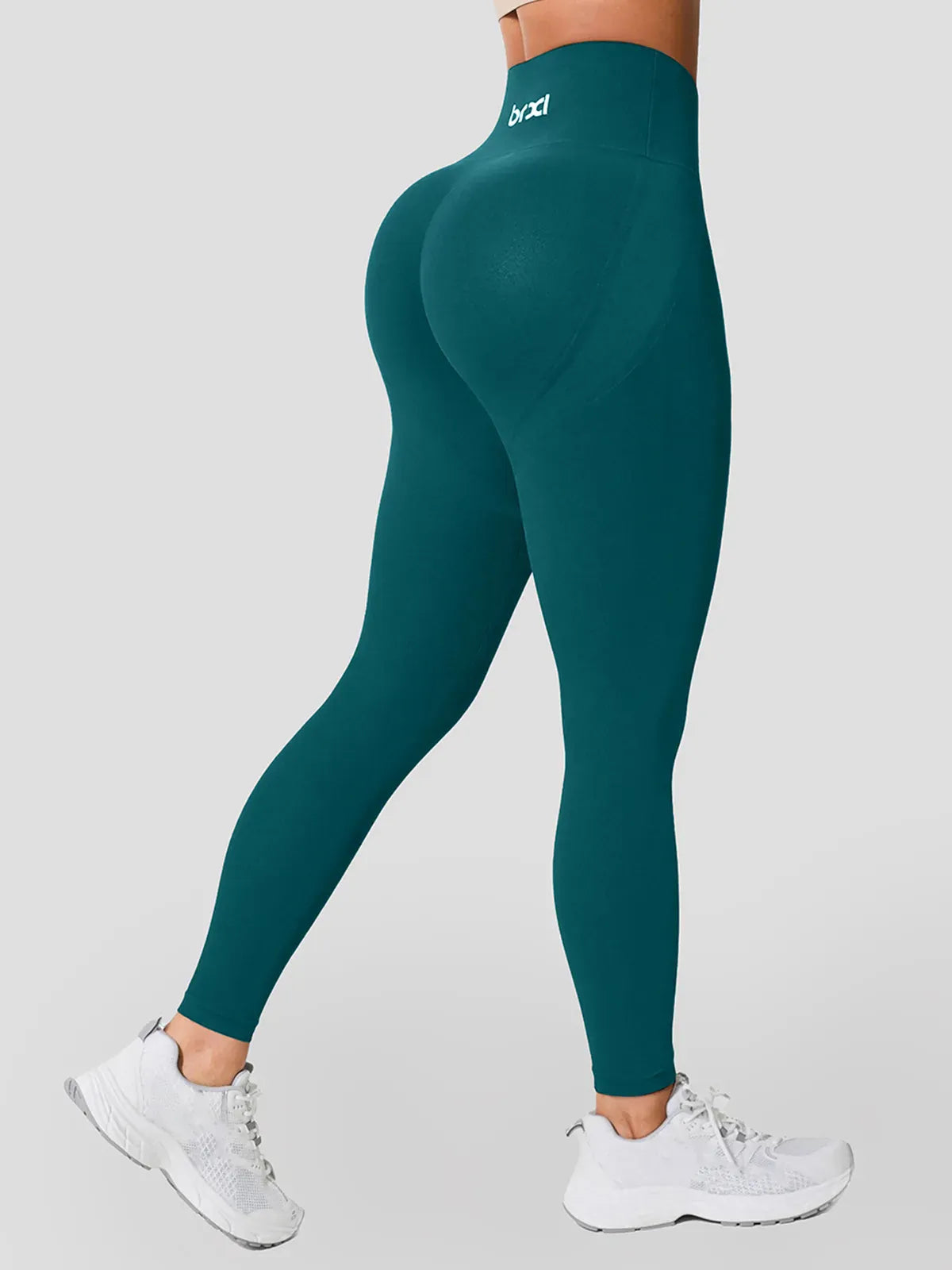 A model wearing a BRXL® High Waisted Seamless Butt-Lifting Leggings With Tummy Control in Green / XS