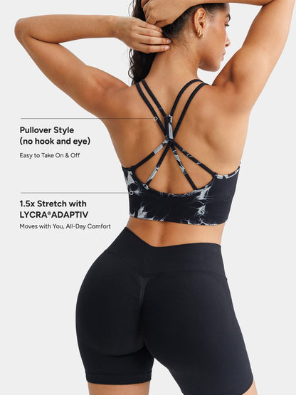 A model wearing a BRXL® B R X L™ Seamless Criss Cross Spaghetti Racerback Sports Bra